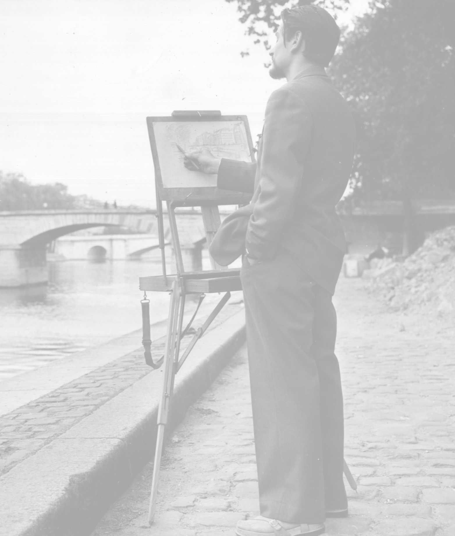 Richard sketching a bridge crossing the Seine River.